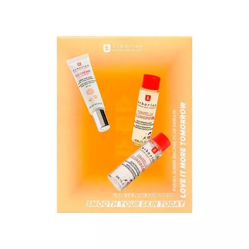 Gros plan du packshot du tube Erborian BB Crème Au Ginseng Doré à côté des flacons d’Huile et Gel Ne