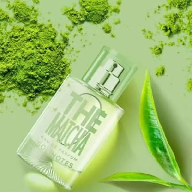 Parfum Solinotes Thé Matcha posé sur une table en bois avec des feuilles de thé vert.