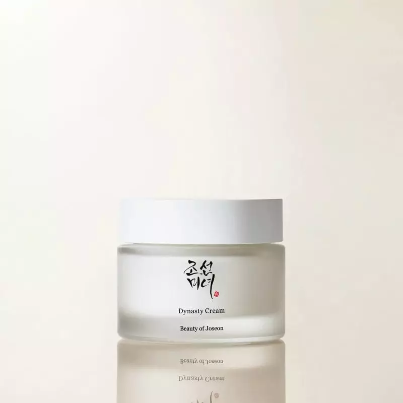 Crème Dynasty Beauty of Joseon packshot élégant sur surface réfléchissante, pot blanc givré avec 'Dy