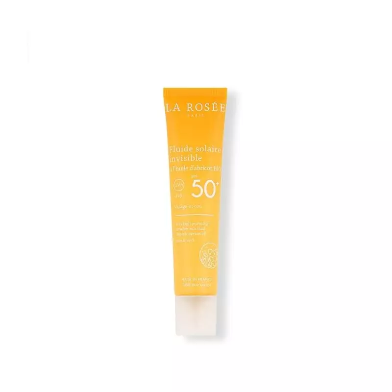 Tube de La Rosée Fluide Solaire Invisible SPF 50+ vu de dessus et de côté sur fond blanc, mettant en