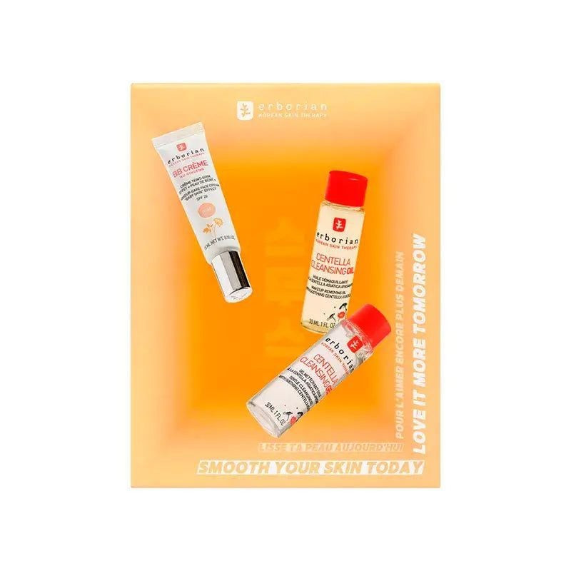 Gros plan du packshot du tube Erborian BB Crème Au Ginseng Doré à côté des flacons d’Huile et Gel Ne