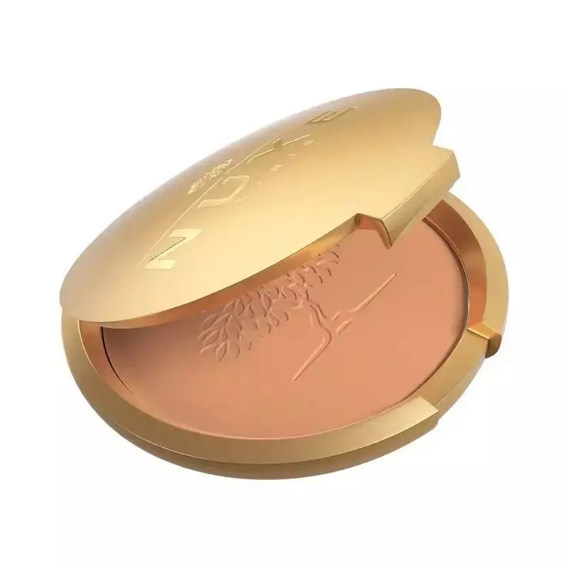 Texture en gros plan de la Poudre Bronzante Prodigieux Nuxe avec fini scintillant.