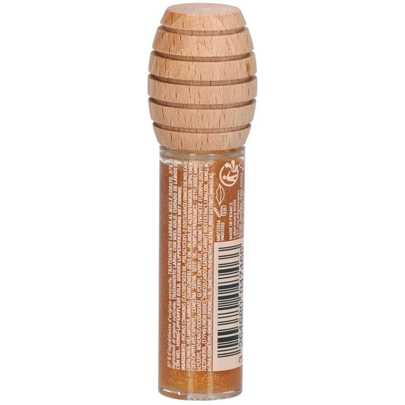 Packshot huile lèvres transparente au miel Nuxe : bouchon bois cuillère miel, applicateur mousse.