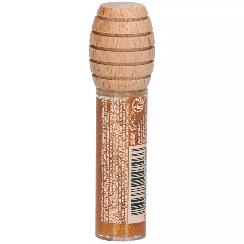 Packshot huile lèvres transparente au miel Nuxe : bouchon bois cuillère miel, applicateur mousse.