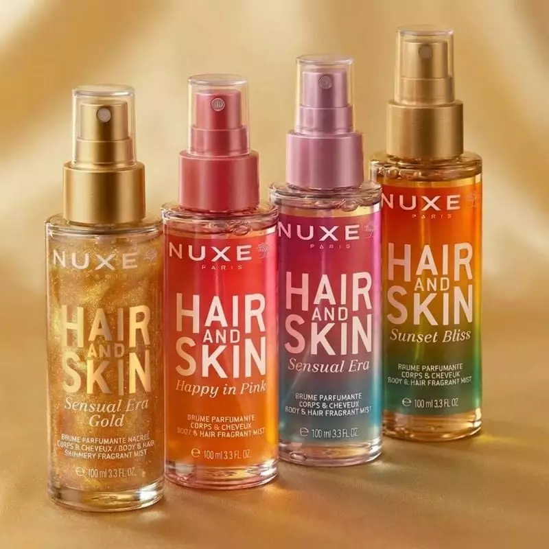 Cadre élégant avec la brume parfumée NUXE Sensual Era Gold et des paillettes dorées.