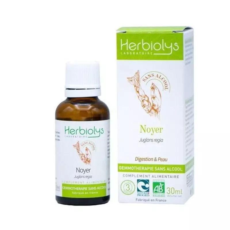 Flacon compte-gouttes en verre de macérât de bourgeons de noyer bio Herbiolys sans alcool, sur fond 