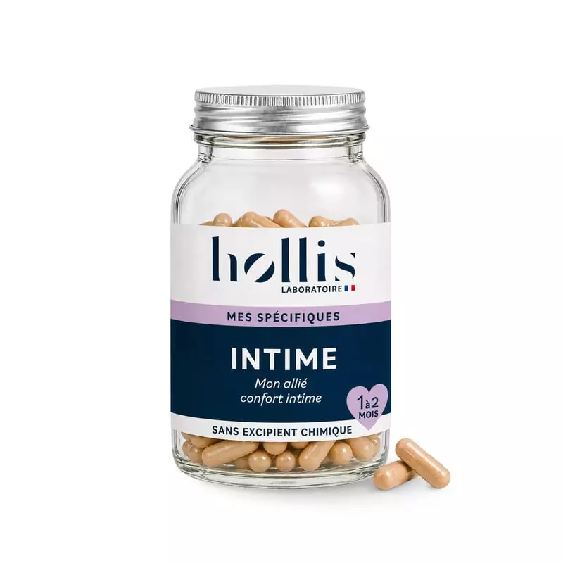 Pot en verre Hollis Intime de 60 gélules beiges avec étiquette bleu marine et rose sur fond blanc