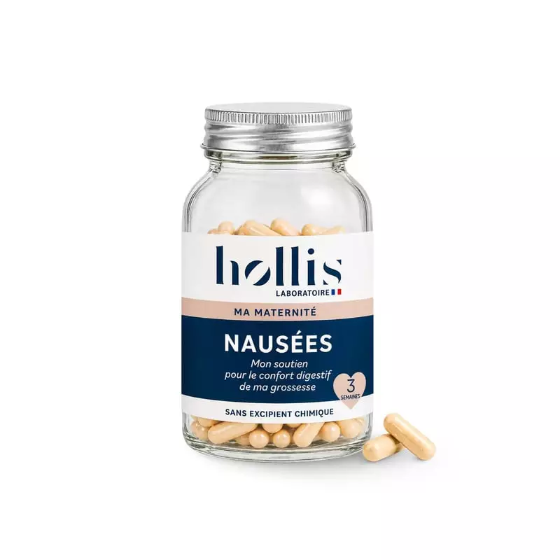 Flacon en verre Hollis Nausées 60 gélules contre les nausées de grossesse, deux gélules beiges sur f